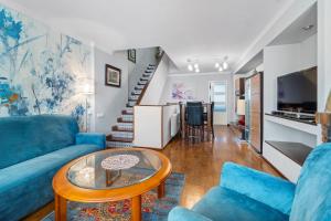 a living room with blue couches and a table at Casa Deti in Roses