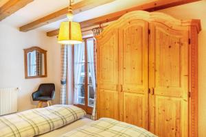 a bedroom with a large wooden cabinet and a bed at Ferienwohnung Reintal in Grainau