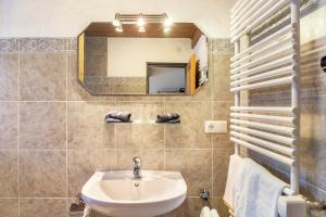 a bathroom with a sink and a mirror and towels at Ferienwohnung Reintal in Grainau +21 photos
