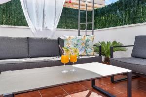 two glasses of orange juice sitting on a table on a patio at Casa Deti in Roses