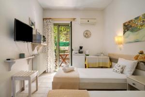 a small room with a bed and a table at Nontas Home 20 in Kalamitsi +17 photos