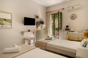 a hotel room with two beds and a balcony at Nontas Home 20 in Kalamitsi