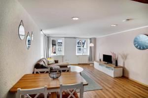 a living room with a table and a couch at Stadtzimmer Im Entenmoos in Bad Waldsee +94 photos