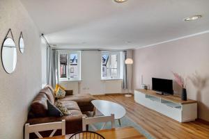 a living room with a couch and a table at Stadtzimmer Im Entenmoos in Bad Waldsee