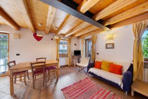 a living room with a table and a couch at Villa Cleila Blu D in San Vito di Cadore