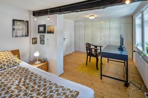 a bedroom with a bed and a desk with a computer at Ferienhaus Schotten in Schotten