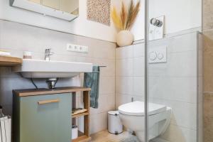 a bathroom with a sink and a toilet at Ferienwohnung z'Dandlberg in Tittmoning +23 photos