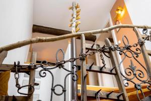a set of stairs with a wrought iron railing at Ferienhaus Annodazumol in Waischenfeld