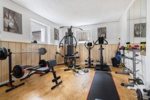 a gym with several treadmills and exercise equipment at Ferienhaus Annodazumol in Waischenfeld +17 photos