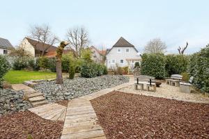 a garden with a bench and a picnic table at Ferienhaus Annodazumol in Waischenfeld