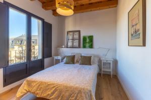 a bedroom with a bed and a large window at Rio Tío Cocinas in La Granja de San Ildefonso