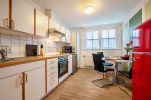 a kitchen with a table and a red refrigerator at Ferienwohnung 2 Soltau in Soltau