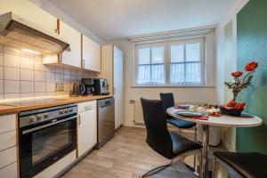 a kitchen with a table and a small table and chairs at Ferienwohnung 2 Soltau in Soltau +10 photos