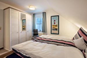 a bedroom with a bed and a chair in it at Ferienwohnung 2 Soltau in Soltau