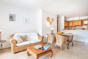 a living room with a couch and a table at Montemar 36 in Port de Soller