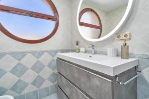a bathroom with a sink and a mirror at Argali Beach Almuñecar in Almuñécar +27 photos