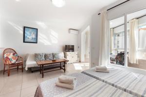 a bedroom with two beds and a living room at Estudios 88 in Torrox +59 photos