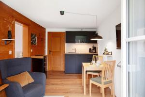 a living room with a blue couch and a table at Ferienwohnung Reschbergwies'n in Farchant