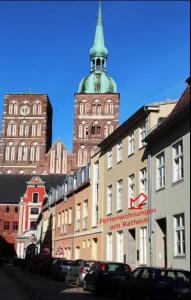 a city street with a tall building with a tower at Ferienwohnung Rügen in Stralsund