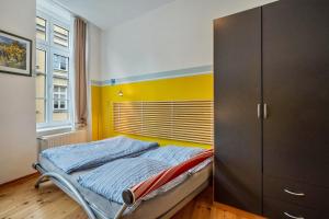 a bedroom with a bed and a cabinet at Ferienwohnung Rügen in Stralsund