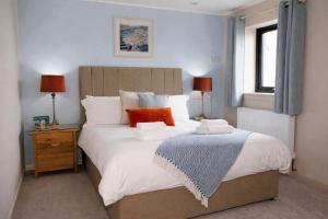 a bedroom with a large bed with two pillows on it at The Foveran in Kirkwall