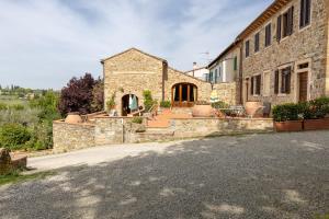 an external view of a stone building with a patio at Podere San Bartolo- Casa colonica 3 in Barberino di Val dʼElsa