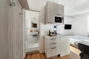 a bathroom with a sink and a shower with a microwave at Dolomiti e Misurina My dreams in Misurina