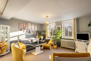 a living room with a couch and a tv at Das Spatzennest in Bad Sachsa