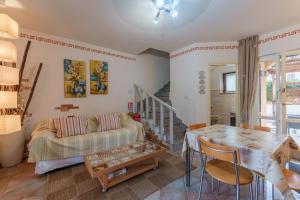 a living room with a couch and a table at Villa Marisol Agrustos in Budoni