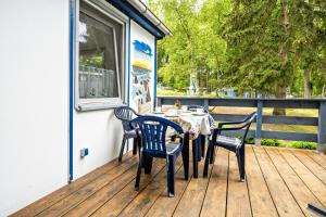 a table and chairs sitting on a deck at Bungalow Kay, Bgl 4 in Dranske +15 photos
