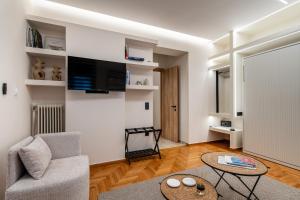 a living room with a couch and a table at The Apex Boutique Apartment B1 in Athens