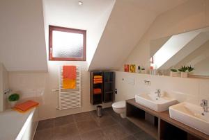 a bathroom with a sink and a toilet and a mirror at Ferienwohnungen Merkle in Wasserburg +94 photos