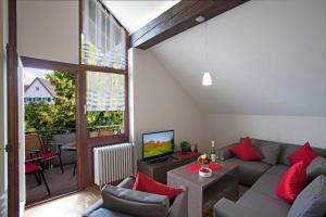 a living room with a couch and a television at Ferienwohnungen Merkle in Wasserburg