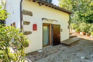 a door to a house with a pathway leading to it at Il Colletto Romantic Stonehouse in Pescia