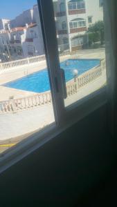 a view of a swimming pool from a window at Roses in Roses