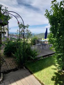 a patio with a table and chairs in a garden at Haus Loks in Sankt Märgen