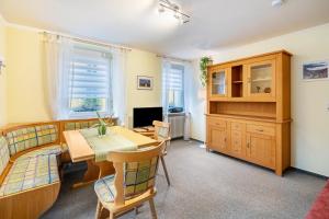a living room with a table and a dining room at Haus Loks in Sankt Märgen
