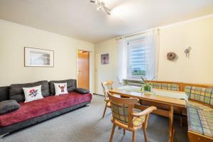 a living room with a couch and a table at Haus Loks in Sankt Märgen
