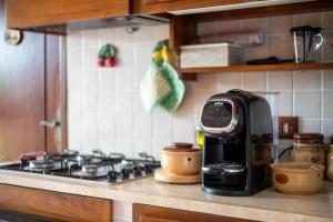 a coffee maker sitting on a stove in a kitchen at Casaletto della musica in Viterbo