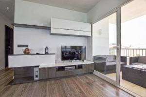 a living room with a flat screen tv on the wall at Son Baulo in Can Picafort