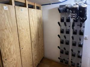 a room with a bunch of knives hanging on a wall at L'edelweiss in La Plagne Tarentaise