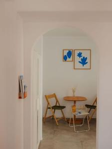 a room with a table and a table and chairs at Adelfia Studios in Parikia