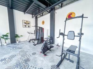 a gym with several tread machines in a room at X Hostel Jogja in Timuran
