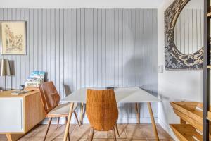 a dining room with a white table and chairs at Échappée Bel in Arveyres +11 photos