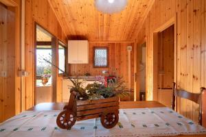 a wooden room with a wooden cart on a table at Casa Ciclamino in Barzio