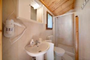 a bathroom with a sink and a toilet at Casa Ciclamino in Barzio +10 photos