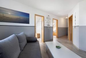 a living room with a couch and a table at Ferienwohnung Thomée in Looft