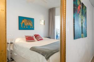 a mirror in a bedroom with a bed with two pillows at Casa Altea-mar in Altea +21 photos