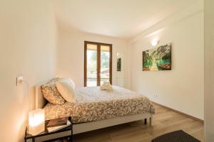 a bedroom with a bed and a window at Como home residence in Carlazzo +97 photos