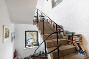 a spiral staircase with books and a window at Buchhaus Vier - Erdgeschoss in Kirchenlamitz